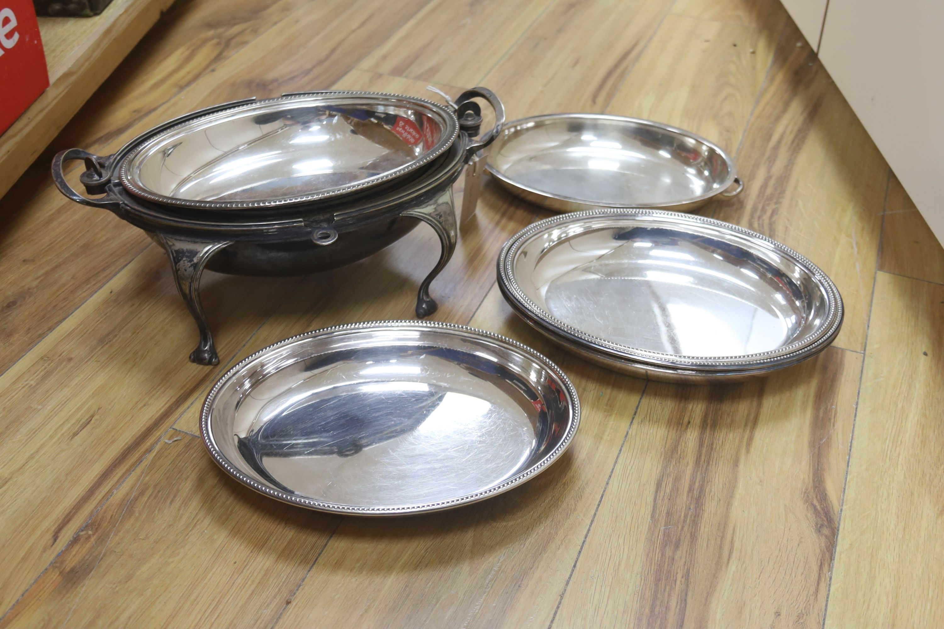 A collection of plated serving dishes, including an oval roll-top breakfast dish, two pairs of entree dishes and covers and two other entree dishes and covers (one missing handle)